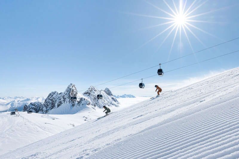Skiing in St. Anton am Arlberg with gondola lift in the background