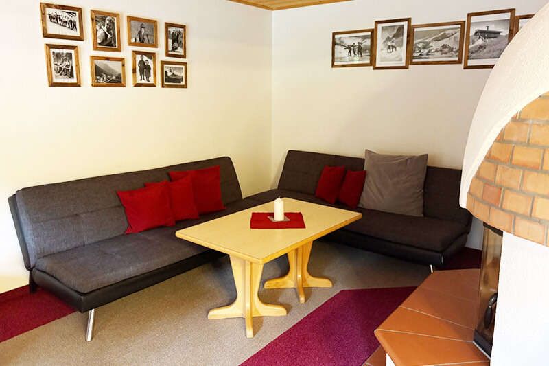 Seating area in front of the tiled stove