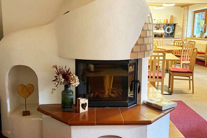 Fireplace in the breakfast room at Haus Sattelkopf